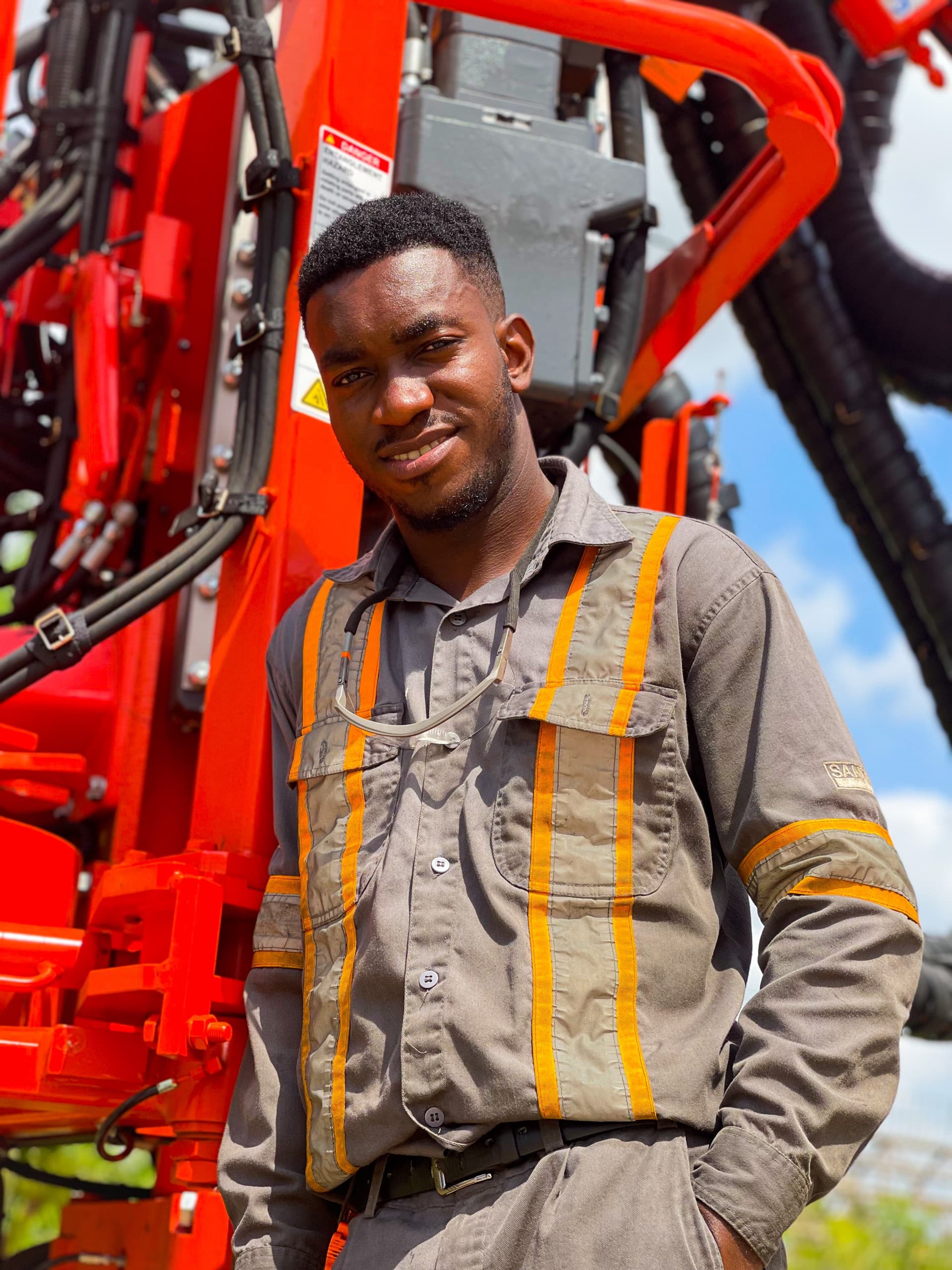 A picture of me beside a drilling machine at Sandvik’s workshop